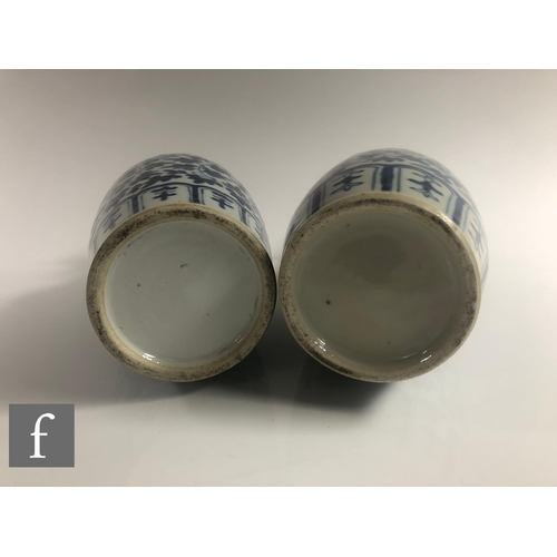 15 - A pair of Chinese late Qing Dynasty blue and white vases, of slender ovoid form rising to a scallope... 