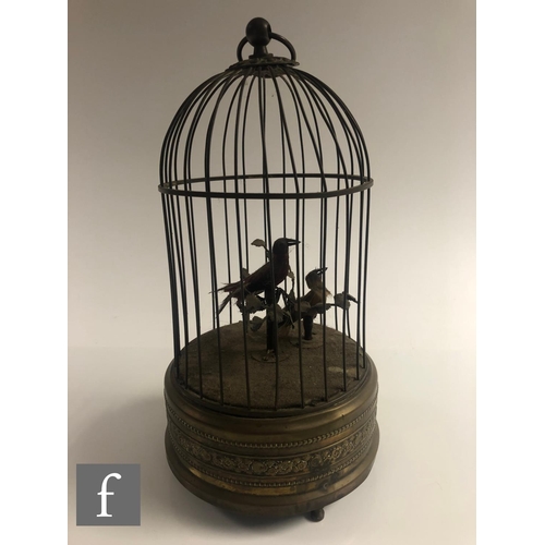 364 - An early 20th Century Griesbaum two singing birds in a brass cage, both birds move and sing, height ... 