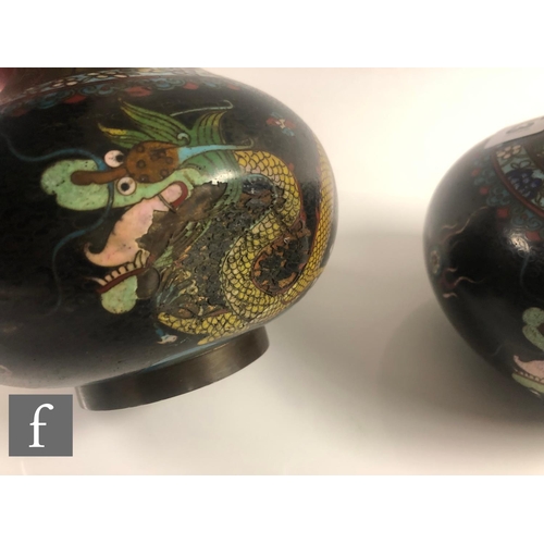 43 - A pair of late Qing Dynasty Chinese cloisonne vases of bottle form, enamelled with two dragons in pu... 