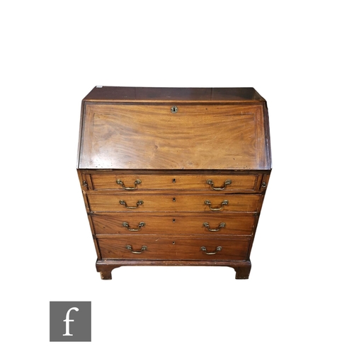 573 - A George III mahogany bureau, the fitted drawer and pigeon hole interior enclosed by a fall, over fo... 