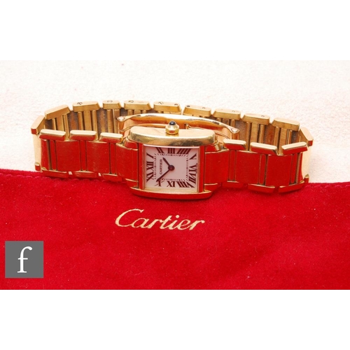 A lady's 18ct hallmarked Cartier Tank Francaise wrist watch Ref 2385, Roman numerals to a white enamelled dial, case width 20mm, to an 18ct bracelet, sold with box, suede pouch, receipt of purchase, guarantee card with red card holder, watch booklet and service receipt from 2019.