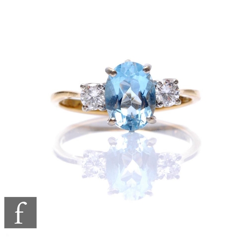 269 - An 18ct hallmarked aquamarine and diamond three stone ring, central oval aquamarine flanked by a sin... 