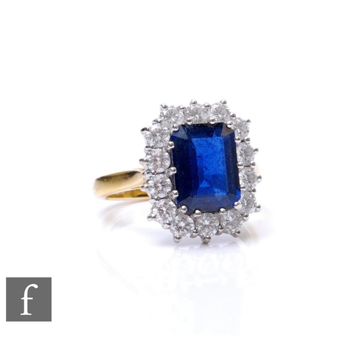 278 - An 18ct hallmarked sapphire and diamond cluster ring, emerald cut sapphire, weight 3.36ct, within a ... 