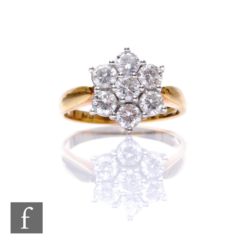 280 - An 18ct hallmarked diamond cluster ring, seven claw set brilliant cut stones, total weight approxima... 