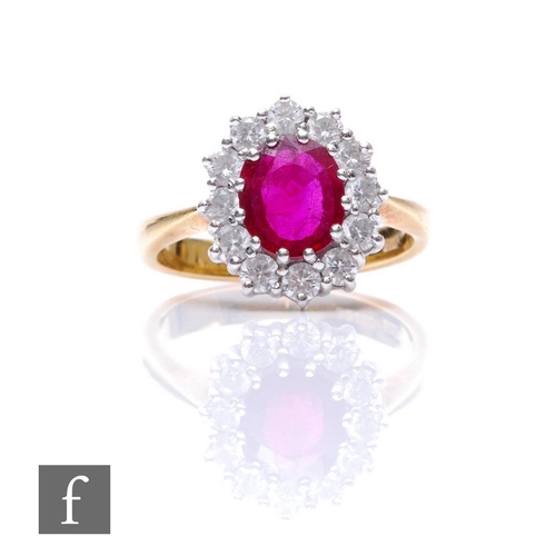 281 - An 18ct ruby and white sapphire cluster ring, central oval ruby, length 8mm, within a border of twel... 