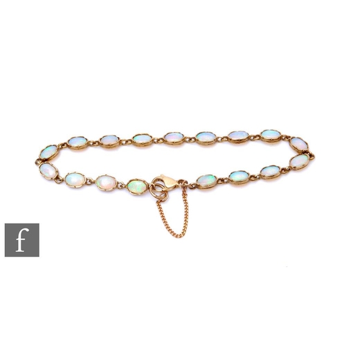 287 - A 9ct opal bracelet comprising seventeen oval collar set opals, total weight 5.4g, terminating in lo... 