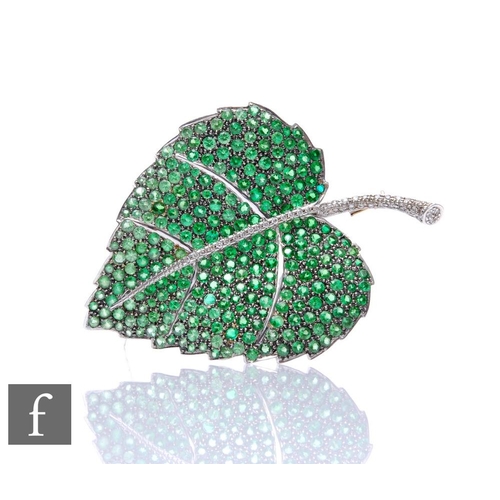 289 - An 9ct white gold tsavorite and diamond brooch modelled as a leaf with diamond set spine and tsavori... 