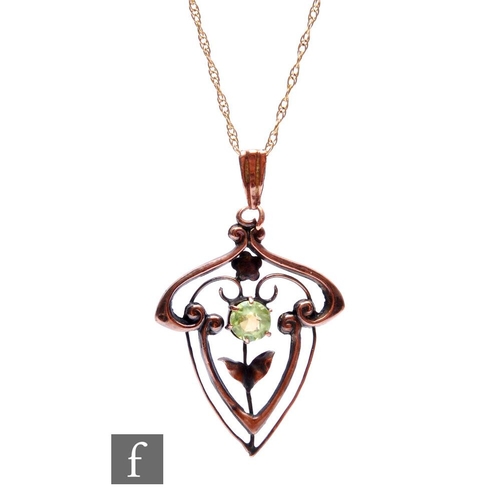 316 - An Edwardian 9ct open work pendant set with a single peridot and suspended from a fine trace chain, ... 