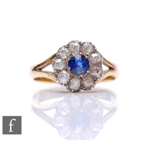 330 - An early 20th Century 18ct sapphire and diamond daisy cluster ring, central sapphire within a border... 