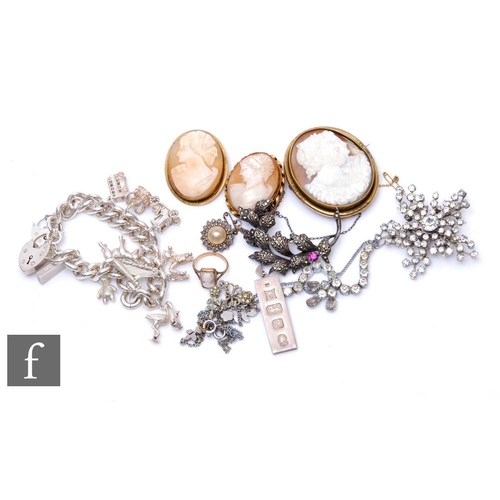 498 - A silver curb link charm bracelet with a silver ingot three cameo brooches and a similar ring etc. (... 