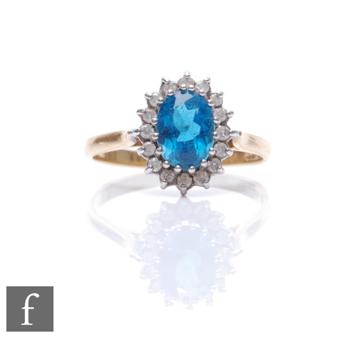 501 - An 18ct hallmarked blue zircon and diamond cluster ring, central zircon within a diamond set border,... 