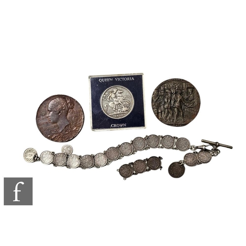 577 - A Victoria 1892 crown, a 1887 bronze medallion, a threepence coin bracelet, damaged, and a Lusitania... 