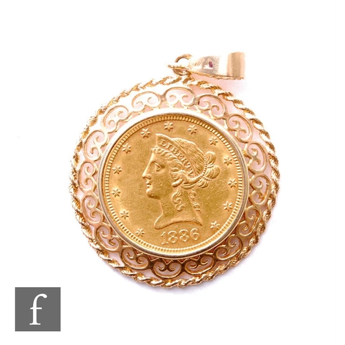 619 - An American 1886 ten dollars in pierced gold frame with suspension loop, weight 24g.