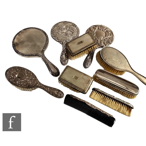 86 - A parcel lot of hallmarked silver backed hair and clothes brushes with three similar hand mirrors, v... 