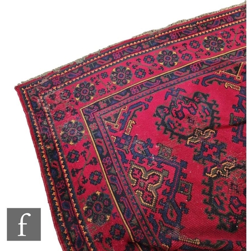 521 - A 20th Century Turkish carpet in traditional deep red ground within multi border.