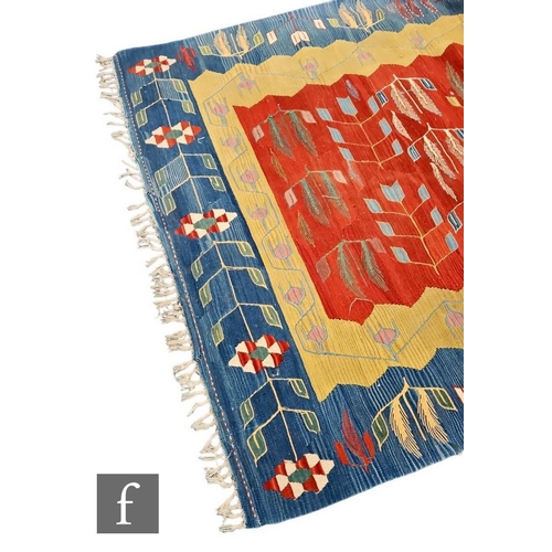 522 - A Soumac flat weave rug, central red ground within a yellow and blue bordered leaf design, 244cm x 1... 