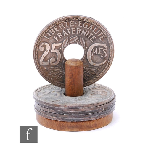 258 - A set of six 1960s French bottle coasters with wooden stand, bearing the date 1924, for 25 Centimes,... 