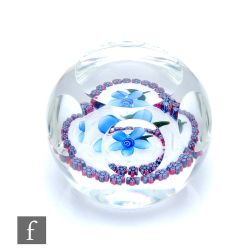 871 - A contemporary Peter McDougall glass paperweight, internally decorated with a lampwork blue flower a... 