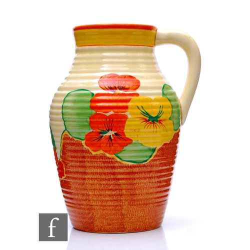 154 - A Clarice Cliff Nasturtium single handled Lotus jug circa 1934, hand painted with stylised flowers a... 