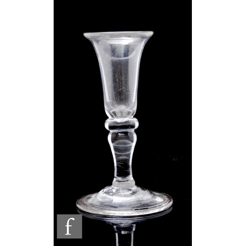 834 - A small 18th Century gin glass circa 1740, the slender bell form bowl with a wide flared rim, above ... 