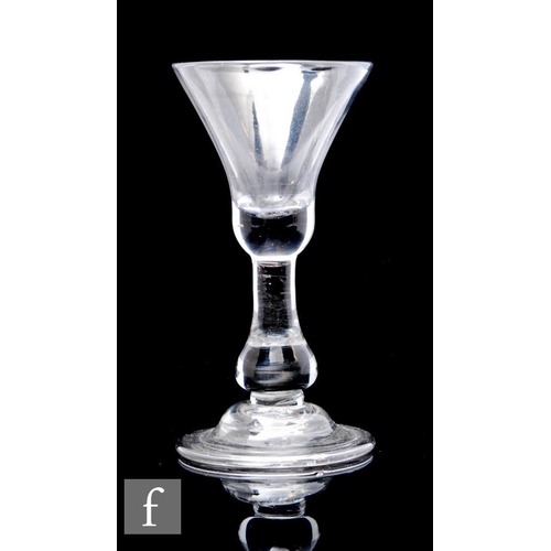 835 - An 18th Century drinking glass circa 1720, the bell form bowl with solid base above a true baluster ... 