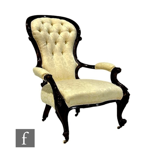 481 - A Victorian carved mahogany easy chair upholstered in cream buttoned back style damask, on cabriole ... 