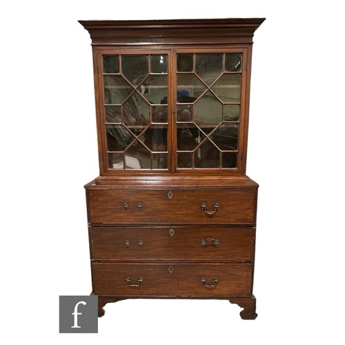 491 - A George III mahogany secretaire bookcase enclosed by a pair of astragal glazed doors below a fluted... 