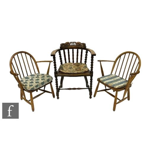 499 - A 1920s carved oak barley twist elbow chair and a pair of ash stick back elbow chairs. (3)