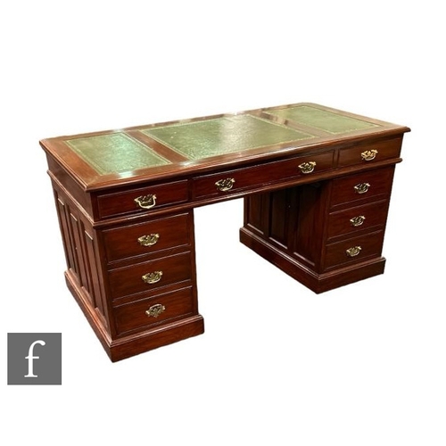 501 - A George III style mahogany knee hole desk, green tooled leather inset top fitted with three drawers... 