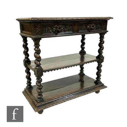 511 - A Victorian carved oak two tier buffet, twin mask handled drawers below a hinged top, on four spiral... 