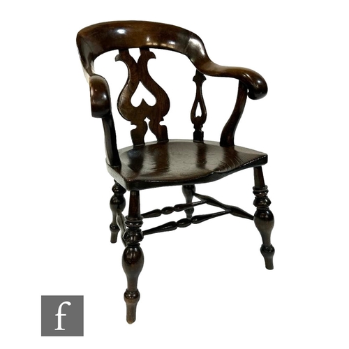 514 - A 19th Century smokers bow elbow chair, shaped elm seat on turned legs united by stretchers.