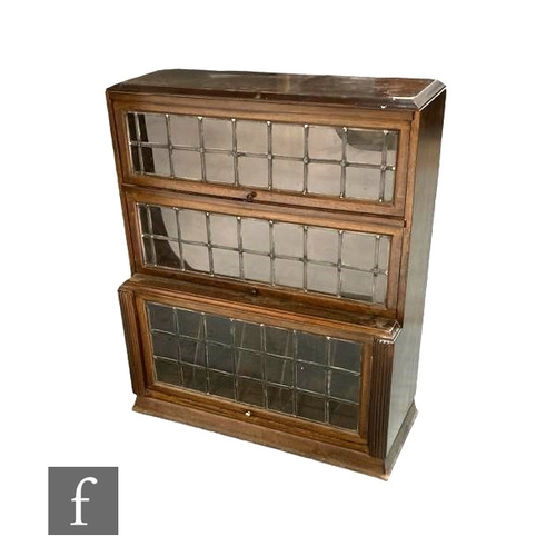 520 - A 1930s oak glazed leaded light three sectional bookcase height 108cm x depth 37cm x width 90cm