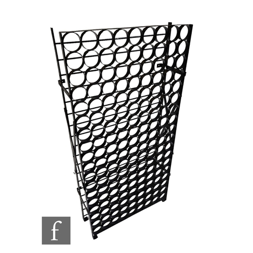 526 - A large one hundred and sixty two bottle wine rack, the black painted metal frame with circular wine... 