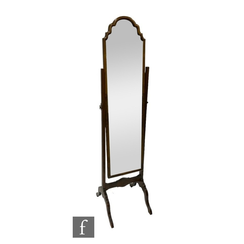 528 - A second quarter 20th Century walnut framed cheval mirror on splayed feet, height 162cm and width 39... 