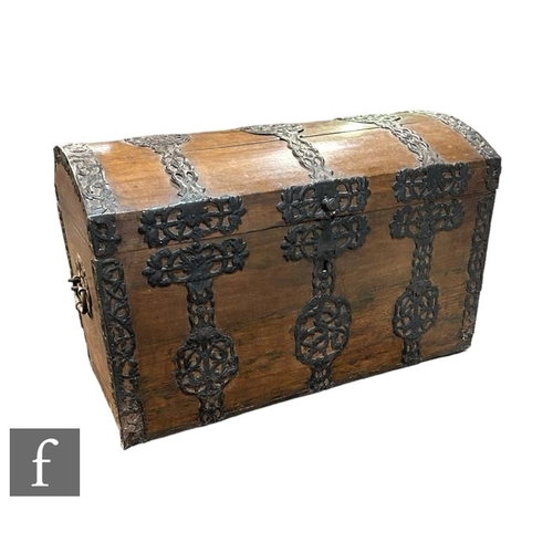 530 - A late 19th Century continental dome topped travelling trunk or sea chest, with decorative acanthus ... 