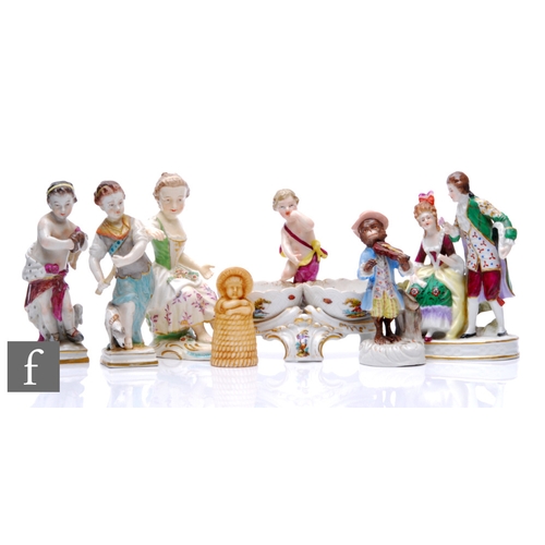 133 - A collection of German porcelain figures, to include a putti salt, a monkey band figure, a Dresden f... 