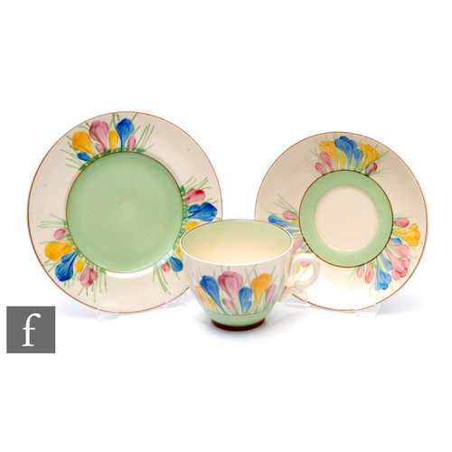 174 - A Clarice Cliff Spring Crocus tea cup, saucer and plate hand painted with stylised flowers and folia... 