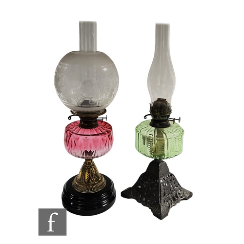 211 - A Victorian brass oil lamp and shade, ruby reservoir on a stepped black glazed terracotta base and a... 