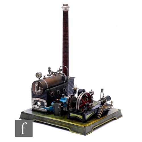 218 - A 1920s German stationary steam plant, mounted horizontal fly wheel and brick effect chimney, on a p... 