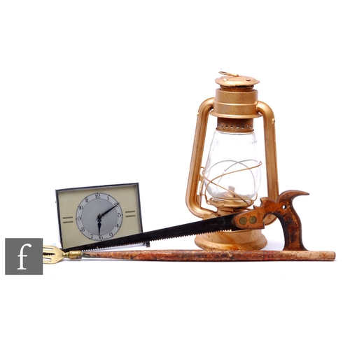 220 - A 1950s bedside clock, a tilly lamp, a handsaw and a toasting fork. (4)