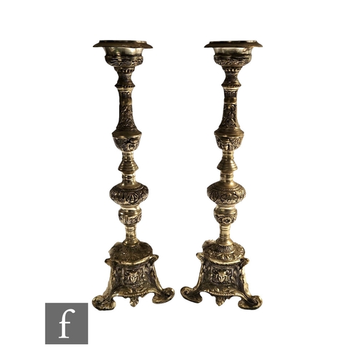 248 - A pair of 20th Century Italianate pricket silvered alter candlesticks on scroll bases and masked pan... 