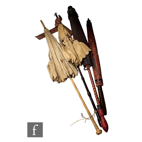 262 - Two early 20th Century embroidered parasols and two simulated bamboo parasols. (4)