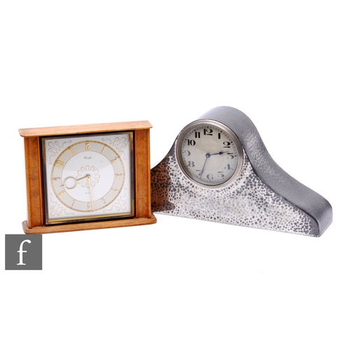 293 - A 1930s Nelson hat type pewter hammered mantle clock and a post 1950s Kienzel mantle clock. (2)