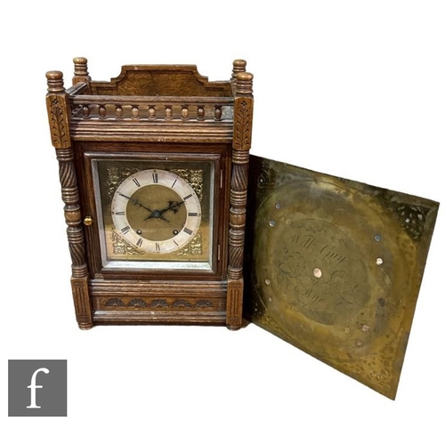 317 - A late Victorian oak mantle clock, eight day striking movement, the square brass dial enclosed by a ... 