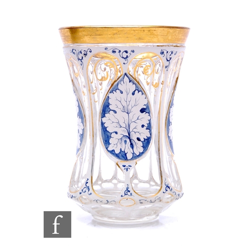 798 - A 19th Century Bohemian beaker of footed and waisted form, cased in opal over clear crystal and cut ... 