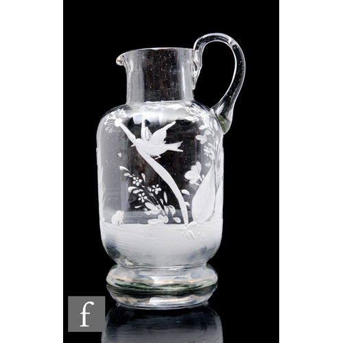 813 - A late 19th Century glass jug of footed form, decorated in the Mary Gregory style with a bird to a b... 