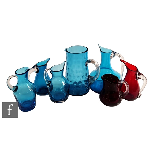 826 - A collection of Whitefriars glass jugs in ruby and kingfisher blue, to include examples with ribbed ... 