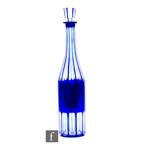 829 - A late 19th Century continental bottle form decanter of slender form, cased in blue over clear cryst... 