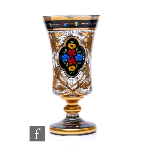 781 - An early 20th Century Bohemian pedestal goblet circa 1920, hand enamelled with floral cartouche pane... 