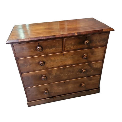 510 - A mid Victorian mahogany straight front chest of two short and three long drawers, turned wood handl... 